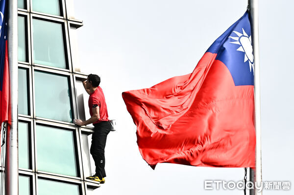 ▲▼美國自由攀岩名將霍諾德（Alex Honnold）於台灣時間25日挑戰徒手攀登台北101，攀爬時剛好與101大樓前懸掛的國旗相互映襯。（圖／記者李毓康攝）